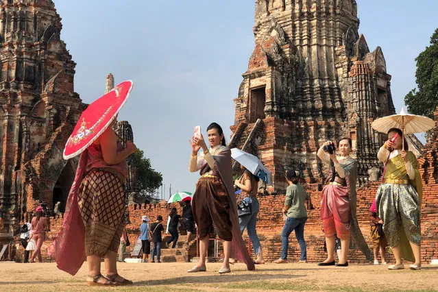 People dressed in traditional costumes pose for a picture, as interest for historical clothing rises within the country, in Ayutthaya, Thailand April 6, 2018. (Photo by Soe Zeya Tun/Reuters)