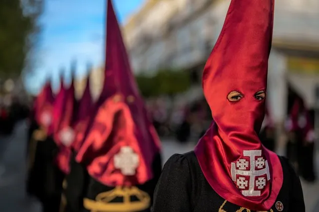 Penitents of the “Dulce nombre de Jesus” brotherhood take part in the “Miserere” procession in Baena, southern Spain, Monday, April 3, 2023. Hundreds of processions take place throughout Spain during the Easter Holy Week. (Photo by Manu Fernandez/AP Photo)