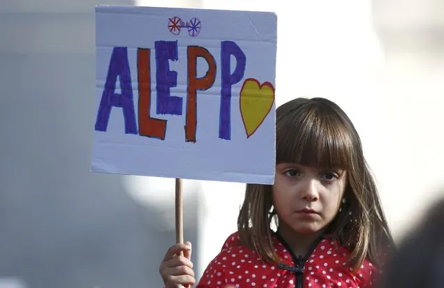 A child holds a placard during a demonstration urging the British government to intervene in the bombing of Aleppo, outside Downing Street, London, Britain October 22, 2016. (Photo by Peter Nicholls/Reuters)