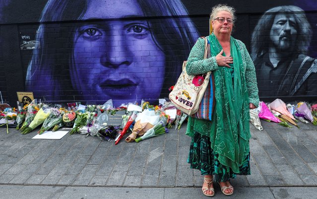 A woman stands in front of a mural of Ozzy Osbourne on Navigation Street, following his death, in Birmingham, Britain, on July 23, 2025. (Photo by Isabel Infantes/Reuters)