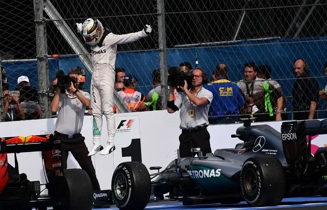 Mercedes AMG Petronas F1 Team British driver Lewis Hamilton celebrates at the end of the Formula One Mexico Grand Prix at the Hermanos Rodriguez circuit in Mexico City on October 30, 2016. Lewis Hamilton kept his world championship hopes alive with victory in the Mexican Grand Prix, Mercedes team-mate Nico Rosberg edged closer to the crown with a second-place finish. Sebastian Vettel, in a Ferrari, was third. (Photo by Pedro Pardo/AFP Photo)