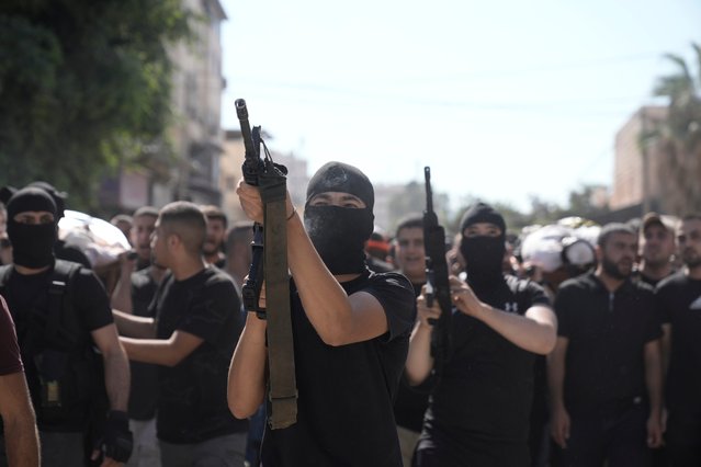Gunmen attend the funeral of five Palestinians killed by an Israeli strike on a vehicle in the West Bank city of Jenin, Tuesday, August 6, 2024. (Photo by Majdi Mohammed/AP Photo)