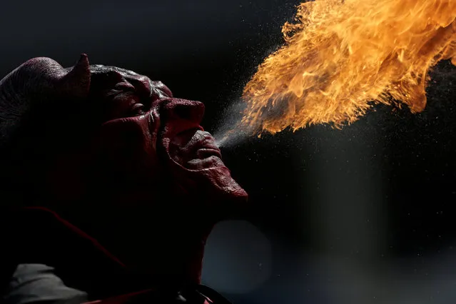 A street performer wearing a devil mask spits fire in Monterrey, Mexico, October 31, 2016. (Photo by Daniel Becerril/Reuters)