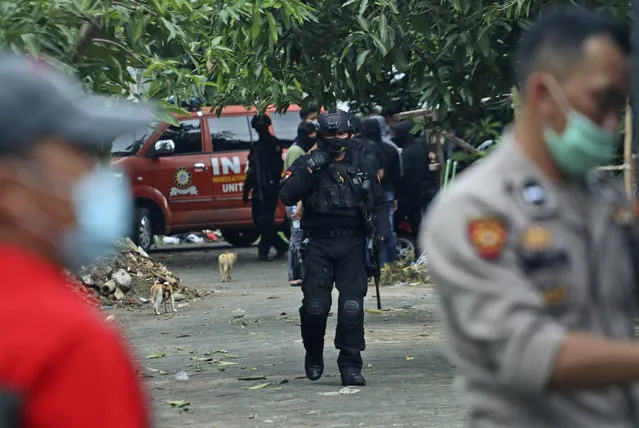 Police officers walk outside the site where two suspected militants were killed during a raid in Makassar, South Sulawesi, Indonesia, Wednesday, January 6, 2021. Members of Indonesia's anti-terrorism police squad killed the two suspected militants who they believe were connected to a deadly suicide attack at a Roman Catholic cathedral in the southern Philippines, officials said. (Photo by Masyudi S. Firmansyah/AP Photo)