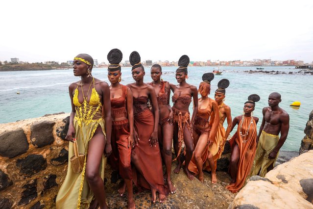 Models showcase designs aboard fishing boats off Ngor Island during the 23rd Dakar Fashion Week, organized by Senegalese-French designer Adama N'Diaye, founder of the brand “Adama Paris”, on December 6, 2025, in Dakar, Senegal. (Photo by Cem Ozdel/Anadolu via Getty Images)