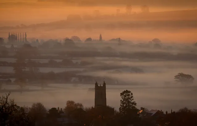 Mist and frost lingers in fields surrounding the village of Evercreech as the winter sun begins to rise on November 24, 2014 in Somerset, England. (Photo by Matt Cardy/Getty Images)