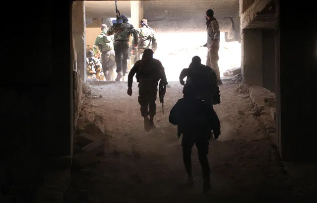 Rebel fighters from the Jaish al-Fatah (or Army of Conquest) brigades gather in position on November 3, 2016, at an entrance to Aleppo, in the southwestern frontline near the neighbourhood of Dahiyet al-Assad, during a rebel offensive to break a three-month siege of the opposition-held east of Syria's second city. Syrian rebels launched a new wave of car bombs and rockets on Aleppo's western districts, redoubling their efforts to break the government's three-month siege of the city. (Photo by Omar Haj Kadour/AFP Photo)