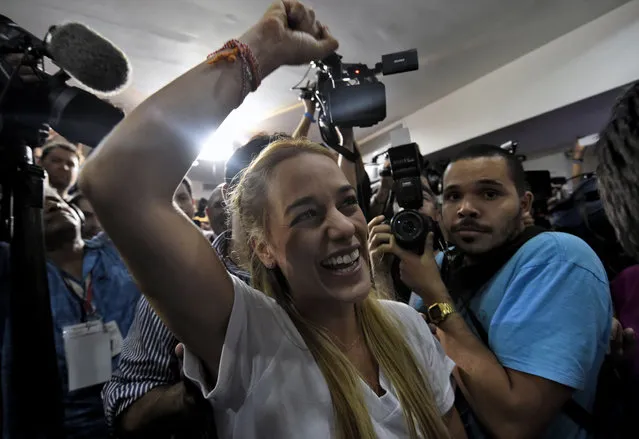 The wife of jailed Venezuelan opposition leader Leopoldo Lopez, Lilian Tintori celebrates after knowing the first results of the legislative election, at the MUD headquarters in Caracas, on the early morning December 7, 2015. Venezuela's opposition won – at least – a majority of 99 out of 167 seats in the state legislature, electoral authorities said Monday, the first such shift in power in congress in 16 years. (Photo by Juan Barreto/AFP Photo)