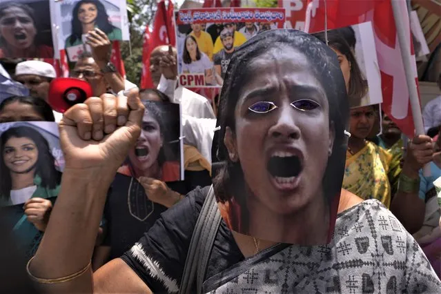 Activists of Communist Party of India (Marxist) covering their faces with photographs of Indian wrestlers shout slogans during a protest rally against the wrestling federation chief over allegations of sexual harassment in Hyderabad, India, Thursday, June 1, 2023. India's top wrestlers have been protesting for more than a month, demanding the resignation and arrest of the president of the wrestling federation for allegedly sexually harassing young athletes. (Photo by Mahesh Kumar A./AP Photo)