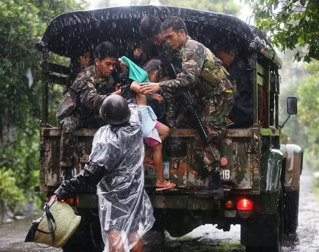 Filipino soldiers assist a child to board a truck bound for evacuation centers in Legazpi City, Albay province, southern Manila, Philippines, 14 December 2015. More than 700,000 people were evacuated in the Philippines as Typhoon Melor slammed into the country's eastern coast, civil defence officials said. Melor was packing maximum sustained winds of 150 kilometres per hour (kph) and gusts of up to 185 kph when it hit land over Northern Samar province, the weather bureau said. (Photo by Zalrian Sayat/EPA)