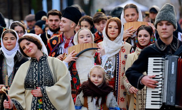 Romanian young people, dressed in traditional peasant suites, parades while performing ancient Christmas Carols during a traditional Christmas show named “Florile Dalbe” (The White Flowers), held at the “Dimitrie Gusti” National Village Museum in Bucharest, Romania, 14 December 2024. Romanians will celebrate Orthodox Christmas on 25 December 2024. (Photo by Robert Ghement/EPA/EFE)