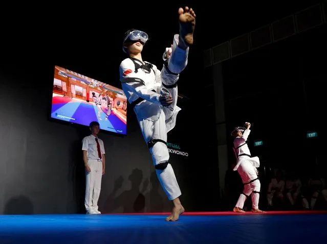 Nigel Tan of Singapore fights against compatriot Alexander Tang in their virtual taekwondo qualifying match at the Olympic Esports Week in Singapore on June 23, 2023. (Photo by Edgar Su/Reuters)