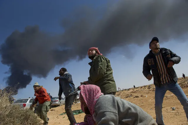 Opposition troops pull back from the main checkpoint near the refinery in Ras Lanuf  as troops loyal to Qaddafi shell the area in Ras Lanuf, in Eastern Libya, March 10, 2011. (Photo by Lynsey Addario/The New York Times)