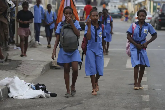 School children walk on the streets at Mene Ela neighborhood, in Malabo, Equatorial Guinea, Monday February 2, 2015. Malabo is holding the African Cup of Nations semifinal match on Thursday between Ghana and Equatorial Guinea at Estadio De Malabo. (Photo by Sunday Alamba/AP Photo)