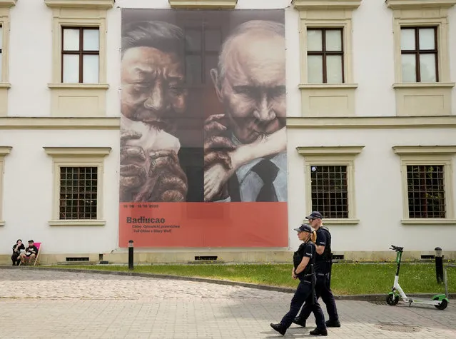 A poster of an exhibition by Chinese dissident artist Badiucao hangs outside the Center for Contemporary Art in Warsaw, Poland on Friday, June 16, 2023. The museum faced demands from the Chinese embassy not to open the exhibition, “Tell China's Story Well”, which is highly critical of China's human rights record. (Photo by Czarek Sokolowski/AP Photo)