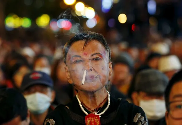 A supporter of Taiwan's New Power Party smokes at a rally ahead of the election in Taipei, Taiwan, January 14, 2016. (Photo by Olivia Harris/Reuters)