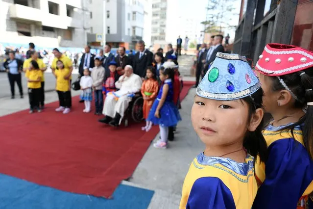 A girl looks on as Pope Francis attends a welcome ceremony at the bishop's house during his Apostolic Journey, in Ulaanbaatar, Mongolia on September 1, 2023. (Photo by Vatican Media/­Handout via Reuters)