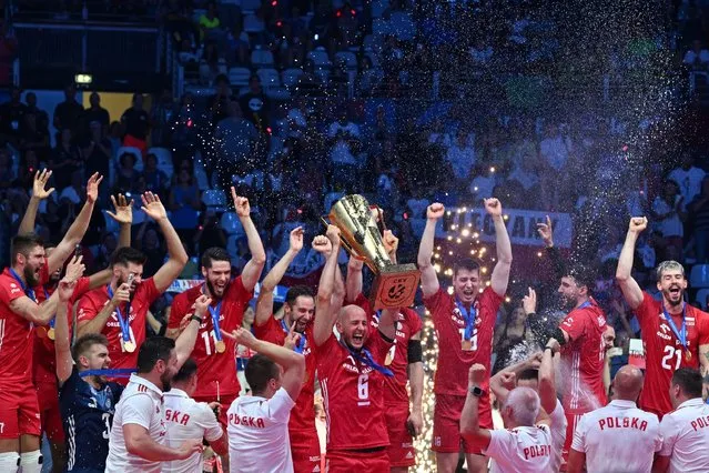 Poland national volleyball team and staff members celebrate on the podium the gold medal after winning the final match between Italy and Poland, at Palalottomatica stadium in Rome, on September 16, 2023. (Photo by Andreas Solaro/AFP Photo)