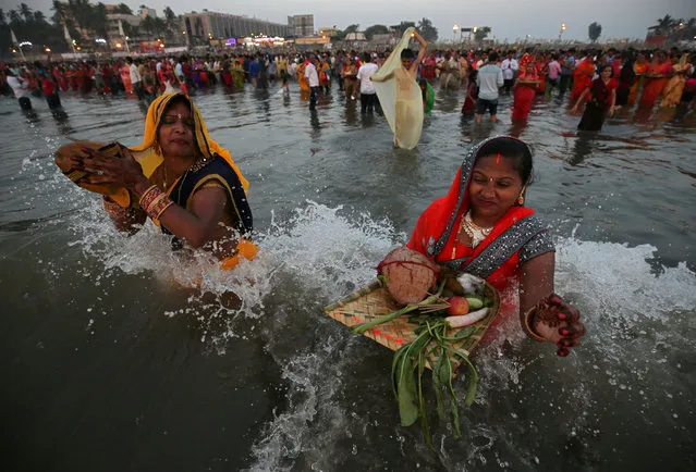 Hindu women react as they worship the Sun god in the waters of the Arabian Sea during the religious festival of Chhath Puja in Mumbai, India, November 13, 2018. (Photo by Francis Mascarenhas/Reuters)