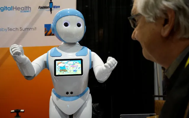 A showgoer looks at the Avatar iPal robot for childen, eldercare and retail  applications at CES in Las Vegas, January 3, 2017. (Photo by Rick Wilking/Reuters)