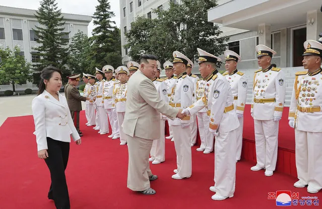 This photo provided on Tuesday, Aug. 29, 2023, by the North Korean government, North Korean leader Kim Jong Un, center left,  with his daughter, left, reportedly named Ju Ae, are greeted during their visit to the navy headquarter in North Korea, on Aug. 27, 2023.  Independent journalists were not given access to cover the event depicted in this image distributed by the North Korean government. The content of this image is as provided and cannot be independently verified. Korean language watermark on image as provided by source reads: “KCNA” which is the abbreviation for Korean Central News Agency. (Photo by Korean Central News Agency/Korea News Service via AP Photo)