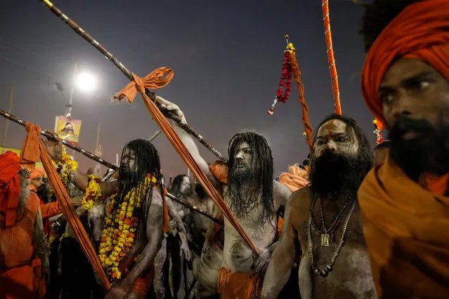 Naga Sadhus or Hindu holy men arrive to take a dip during the first “Shahi Snan” (grand bath) during “Kumbh Mela” or the Pitcher Festival, in Prayagraj, previously known as Allahabad, India, January 15, 2019. (Photo by Danish Siddiqui/Reuters)