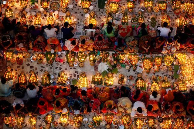 Hindu devotees sit together on the floor of a temple to observe Rakher Upabash for the last day, in Dhaka, Bangladesh, November 15, 2016. (Photo by Mohammad Ponir Hossain/Reuters)