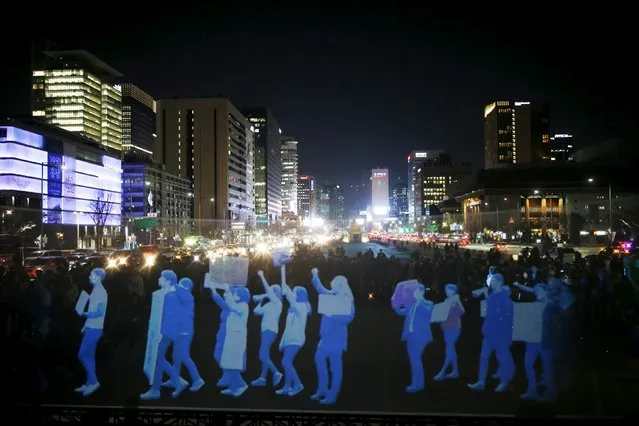 A hologram depicting people marching is projected during a hologram-style rally organised by human rights group Amnesty International to demand to demand freedom of assembly in central Seoul, South Korea, February 24, 2016. (Photo by Kim Hong-Ji/Reuters)