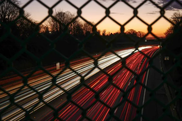 In this long exposure photo, motor vehicles move along Interstate 276 in Feasterville, Pa., Thursday, December 21, 2023. (Photo by Matt Rourke/AP Photo)