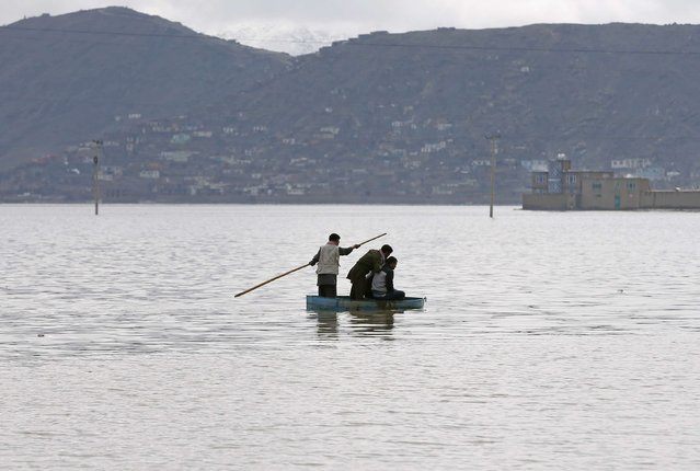 Afghan youths sail on a homemade boat in a lake on the outskirts of Kabul, February 24, 2015. (Photo by Omar Sobhani/Reuters)