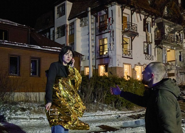 A man helps a female victim at the site of an overnight Russian rocket attack on a hotel in Kharkiv, Ukraine, 10 January 2024. At least 10 people, including one foreign journalist, were injured as a result of two rockets hitting the downtown area of the eastern Ukrainian city of Kharkiv, according to State Emergency Service reports. Russian troops entered Ukrainian territory in February 2022, starting a conflict that has provoked destruction and a humanitarian crisis. (Photo by Sergey Kozlov/EPA/EFE)