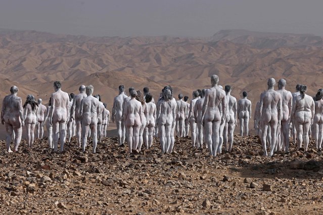 Participants pose nude for American art photographer Spencer Tunick, working on a photo installation in the desert landscape surrounding the southeastern Israeli city of Arad, some 15 kilometre west of the Dead Sea, on October 17, 2021. About 300 participants have registered to be part of the nude photo installation, designed to draw world attention to the importance of preserving and restoring the Dead Sea, a unique natural resource and one of Israel’s most famous tourist attractions. (Photo by Menahem Kahana/AFP Photo)