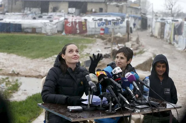 United Nations High Commissioner for Refugees (UNHCR) Special Envoy Angelina Jolie reacts as it rains during a news conference during her visit to Syrian refugees in the Bekaa valley, Lebanon March 15, 2016. March 15 marks the 5th anniversary of peaceful protests against Assad, leading to the devastating civil conflict in the country. (Photo by Mohamed Azakir/Reuters)