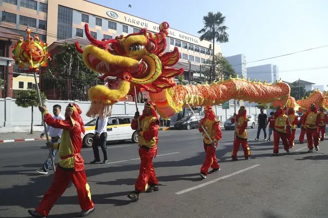Local Chinese artists perform a dragon dance during a cerebration to mark the Lunar New Year at Chinatown Saturday, February 10, 2024, in Yangon, Myanmar. (Photo by Thein Zaw/AP Photo)