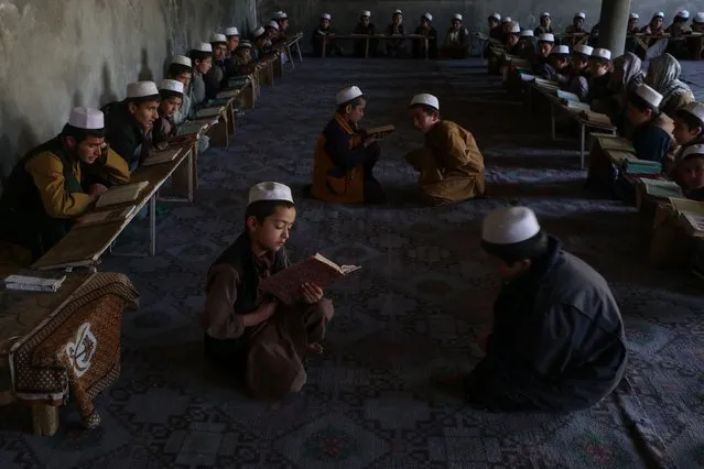 Afghan children read the holy Koran at a madrassa or an Islamic school during the Islamic holy month of Ramadan in the Argo district of Badakhshan province on March 27, 2024. (Photo by Omer Abrar/AFP Photo)