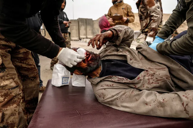 A man injured in a mortar attack is treated by medics in a field clinic as Iraqi forces battle with Islamic State militants, in western Mosul, Iraq March 2, 2017. (Photo by Zohra Bensemra/Reuters)