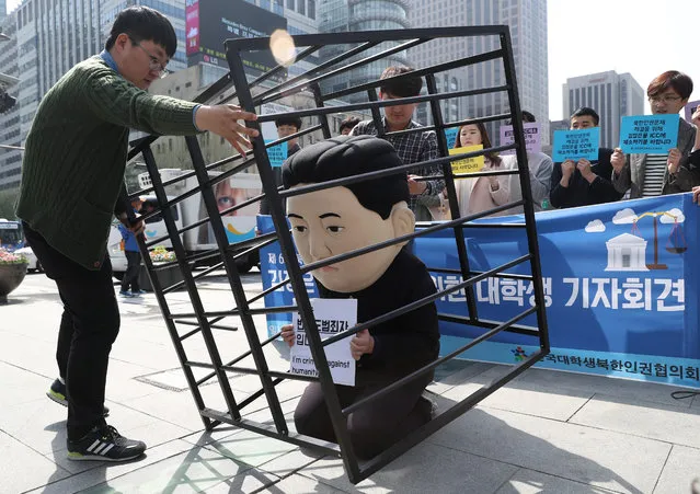 University students put on a performance acting out the jailing of North Korean leader Kim Jong-un, in downtown Seoul, South Korea, 25 April 2016. The performance is part of a three-day campaign arranged by university students across the country to demand that Kim be brought before the International Criminal Court (ICC) for his crimes against humanity. (Photo by EPA/Yonhap)