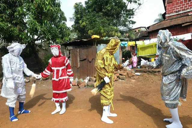 The Kofi Jalloy secret society portraying four devils dancing during a Araba dance performance in Freetown on November 28, 2018. The devils seen are from left to right Baykey (white), Faerie (red), Gargoda (yellow) and Labalaba (gray). (Photo by Lynn Rossi/AFP Photo)