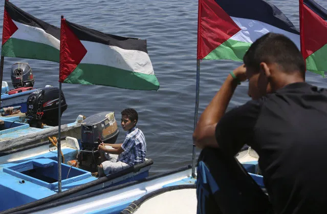Palestinian protesters attend a protest calling to free the Marianne vessel one of four boats sailing to break the blockade on Gaza strip, at the fishermen port in Gaza City, in the northern Gaza Strip, Monday, June 29, 2015. Israel's navy intercepted a Swedish vessel attempting to breach a naval blockade of Gaza early Monday and was redirecting it to an Israeli port, the military and the activists said. (Photo by Adel Hana/AP Photo)