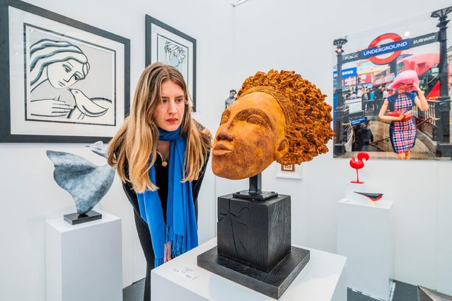 Works on the Synergy Fine Art stand at the Affordable Art Fair in Hampstead Heath, north London on May 8, 2024, include African Queen by Richard Chapman and photographs by Alex Adams. The fair runs until May 12. (Photo by Guy Bell/Alamy Live News)