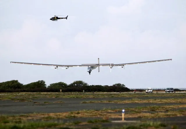 The Solar Impulse 2 airplane, piloted by Andre Borschberg, lands at Kalaeloa Airport in Kapolei, Hawaii, after flying non-stop from Nagoya, Japan, July 3, 2015. The Solar Impulse, which took off from Japan on Monday on the seventh leg of its journey and landed in Hawaii early on Friday, shattered the solo-flight record threshold of 76 hours whilst crossing the Pacific. (Photo by Hugh Gentry/Reuters)