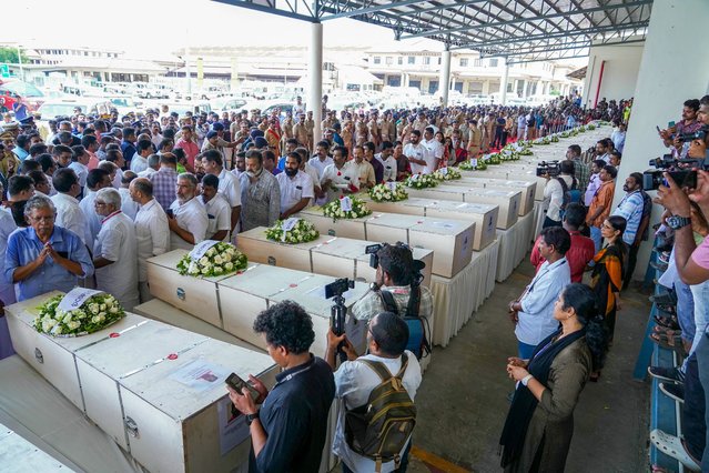 Relatives mourn near the deceased after the coffins' arrival on an Indian Air Force plane from Kuwait at the Cochin International Airport in Kochi on June 14, 2024. Grieving families kept a solemn vigil in the terminal of an Indian airport on June 14 as the bodies of dozens of migrant workers killed in a Kuwait building fire returned home. Wednesday's dawn blaze quickly engulfed a housing block home to some of the many foreign labourers servicing the oil-rich gulf state's economy. (Photo by Arun Chandrabose/AFP Photo)