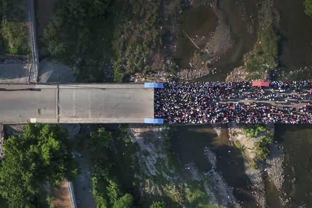 People wait in Ouanaminthe, Haiti, to cross into Dominican Republic, May 17, 2024. (Photo by Matias Delacroix/AP Photo)