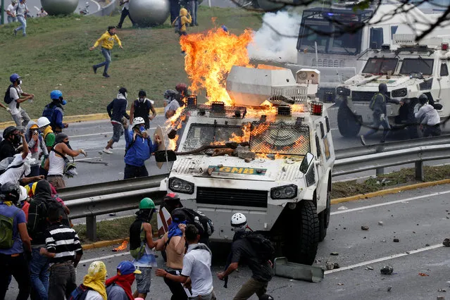 Demonstrators clash with a riot police armored car during a rally against Venezuela's President Nicolas Maduro in Caracas, Venezuela on May 2, 2017. (Photo by Carlos Garcia Rawlins/Reuters)