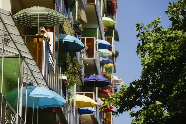 Colorful umbrellas on the balconies of the Ujpalota housing estate in Budapest, Hungary, Wednesday, July 22, 2015. (Photo by Zoltan Balogh/MTI via AP Photo)