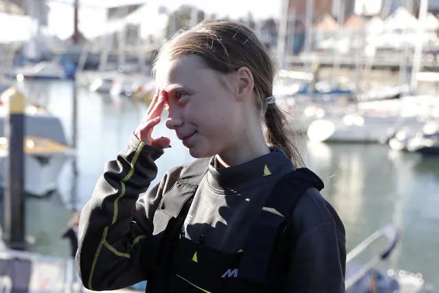 Climate activist Greta Thunberg gives an interview on the quayside in Lisbon, after arriving aboard the sailboat La Vagabonde, Tuesday, December 3, 2019. Thunberg has arrived by catamaran in the port of Lisbon after a three-week voyage across the Atlantic Ocean from the United States. The Swedish teen sailed to the Portuguese capital before heading to neighboring Spain to attend the U.N. Climate Change Conference taking place in Madrid. (Photo by Armando Franca/AP Photo)