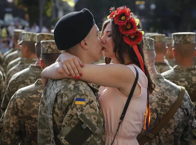 A Ukrainian serviceman gives his girlfriend a kiss at Kiev's Independence Square, Ukraine, 24 August 2015, before a march on the occasion of Independence Day. Ukrainians marked the 24th anniversary of Ukraine's independence from the Soviet Union in 1991. (Photo by Roman Pilipey/EPA)