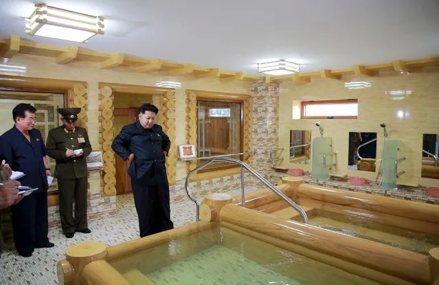 North Korean leader Kim Jong Un (R) gives guidance during his visit to the newly-built Pyongyang Home for the Aged in this undated photo released by North Korea's Korean Central News Agency (KCNA) on August 2, 2015. (Photo by Reuters/KCNA)