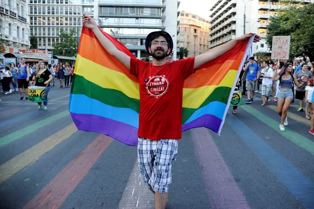 A gay rights activist crosses a rainbow-coloured pedestrian crossing during a gay pride parade in Athens, June 11, 2016. (Photo by Michalis Karagiannis/Reuters)
