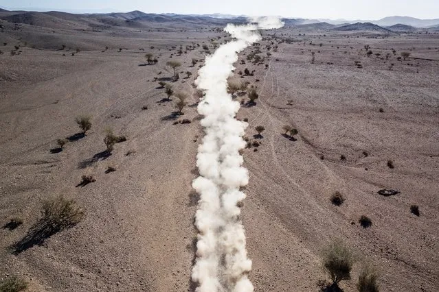 A tail of dust from a race car is seen during stage two of the Dakar Rally, between Al Wajh and Neom, Saudi Arabia, Monday, January 6, 2020. (Photo by Bernat Armangue/AP Photo)